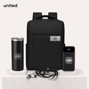 May include: A black backpack, a black tumbler, and a black power bank with a digital display. Each item features a rectangular label with the text YOUR LOGO HERE. A black charging cable with multiple connectors is coiled in the foreground.