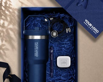 May include: A navy blue gift box containing a navy blue insulated tumbler with a handle, a black multi-charging cable, a navy blue pen, and a white wireless earbud case. Each item features the text YOUR LOGO HERE, with the box lid showing the same.