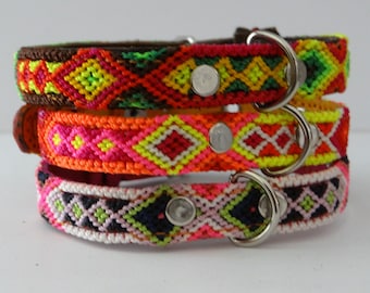 May include: Three colourful dog collars with a diamond pattern. The collars are made of woven string and have silver metal D-rings and a silver metal buckle.