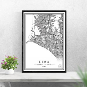 May include: Black and white map print of Lima, Peru with the city's name and coordinates: 12.046°S / 77.042°W. The map is framed in a black frame and is displayed on a white surface.