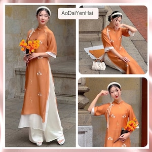 May include: Three women wearing orange and white traditional Vietnamese dresses, known as Ao Dai, with floral embroidery. The dresses are paired with white trousers. The women are holding bouquets of yellow flowers and posing in different settings.