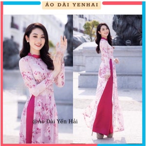 May include: A light pink Áo dài dress with a floral pattern and long sleeves. The dress has a high collar and a split skirt, paired with magenta pants. The text "Áo Dài Yến Hải" is at the top, and "@Áo Dài Yến Hải" is at the bottom.