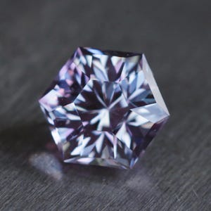 MADE TO ORDER. Hexagon purple to steely blue lab sapphire. Precision cut in a pear design. Vanadium corundum made by Czochralski method.