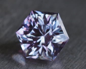 MADE TO ORDER. Hexagon purple to steely blue lab sapphire. Precision cut in a pear design. Vanadium corundum made by Czochralski method.
