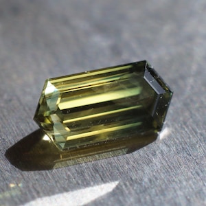 2.4 carat Australian Sapphire in an elongated hexagon design. 11.1 x 5.6 mm. Yellow and green parti bicolor natural stone