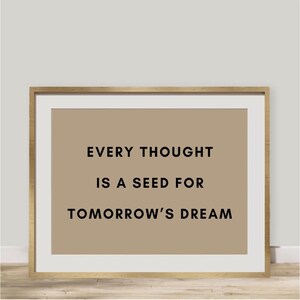 May include: A framed print with a beige background and black text that reads "Every thought is a seed for tomorrow's dream."