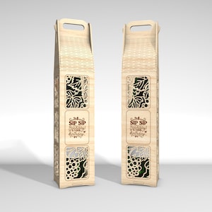 May include: Two wooden wine bottle gift boxes with laser-cut grape and leaf designs. Each box has a handle and the text "SIP SIP Hooray! It's your birthday". The boxes are made of light-colored wood.