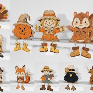 May include: A collection of ten wooden shelf-sitting figures featuring autumn and harvest themes. The characters include a turkey, a pumpkin, a scarecrow, a squirrel, a pilgrim child, a fox, a farmer, a crow, and a highland cow, all with dangling legs.