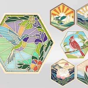 May include: Six hexagonal stained glass panels featuring nature scenes. The panels depict a hummingbird with a purple flower, a cardinal with red feathers, a sunrise over a mountain range, a daisy with blue sky, a pink peony with a sunset, and a pink tulip with a blue sky.