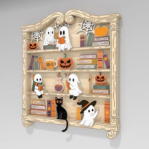 May include: Wooden Halloween-themed bookshelf with carved details. Features ghosts, pumpkins, books, a black cat, and a witch hat. The bookshelf has multiple shelves with decorative elements, perfect for seasonal decor.