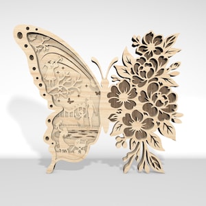 Peut inclure: Décoration en bois en forme de papillon avec des motifs découpés complexes. Une aile présente un paysage détaillé, l'autre des motifs floraux. La couleur naturelle du bois ajoute de la chaleur à cette pièce décorative.