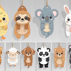 May include: A collection of wooden animal ornaments, including a chick, sloth, koala, rabbit, tiger, sheep, dog, panda, bear, and cat. Each ornament is suspended by a natural twine string, perfect for hanging. The ornaments are painted in various colors.