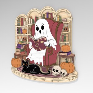 May include: A wooden Halloween-themed decoration featuring a ghost reading a book in a red armchair. A black cat, pumpkins, and skulls are also present. The background includes a bookshelf with books and candles.