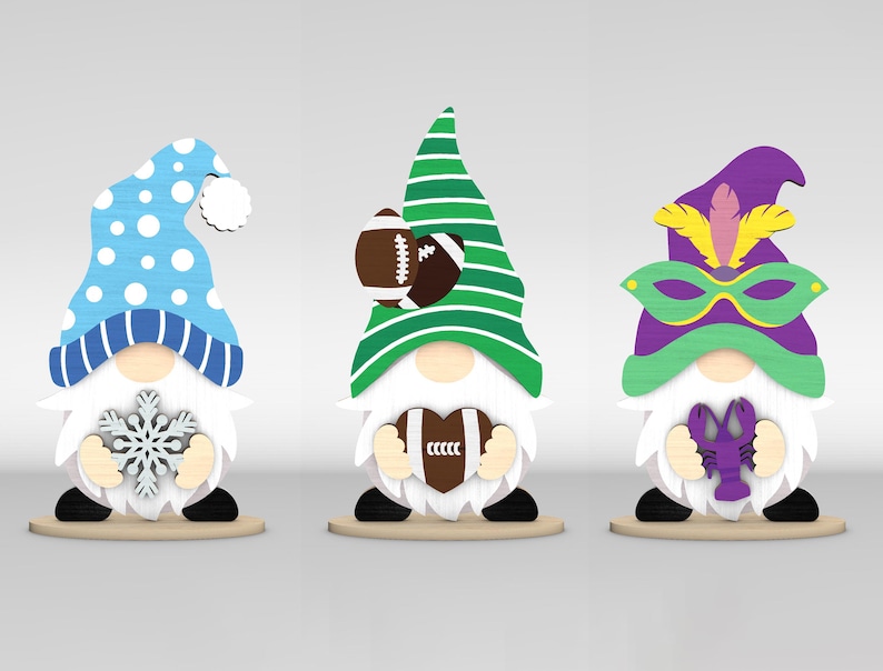 May include: Three wooden gnome figurines. One gnome wears a blue and white winter hat and holds a snowflake. Another gnome has a green and white striped hat and a football. The third gnome has a purple hat and a mask, holding a purple crawfish.