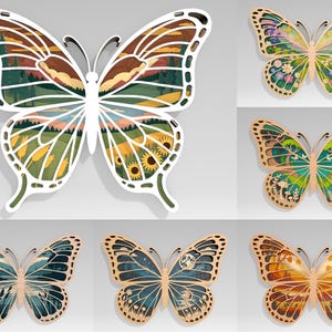 Op de afbeelding: Een verzameling van zes gelaagde houten vlinder wandkunstwerken. Elke vlinder heeft een uniek landschapsontwerp, met kleuren als groen, geel, bruin en blauw. De vlinders hebben een witte of natuurlijke houten lijst.