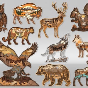 May include: A selection of layered wooden animal cutouts, including an owl, bison, deer, squirrel, cougar, wolf, fox, eagle, bear, and moose. Each piece features a detailed landscape scene with trees, mountains, and wildlife, in shades of brown and tan.