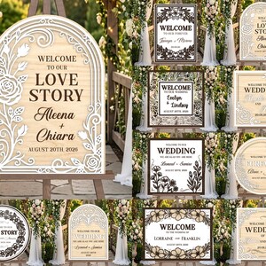 May include: A collection of wooden wedding signs with various designs. The main sign features an arch shape with floral cutouts and the text "Welcome to our Love Story Aleena + Chiara August 20th 2026". Other signs include floral and geometric designs.