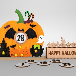 May include: A wooden Halloween countdown calendar featuring a pumpkin, bats, a ghost, a cauldron, and a castle. The calendar displays the number 28 and the text "Countdown to Halloween". It also includes a box with the text "Happy Halloween" and a row of pumpkins with various expressions.