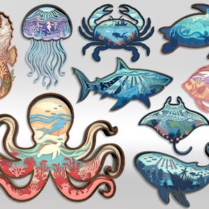 May include: A collection of layered wooden sea creature cutouts, including a seahorse, jellyfish, crab, turtle, shark, fish, octopus, manta ray, and whale. Each piece features intricate interior designs with ocean scenes and various colors.