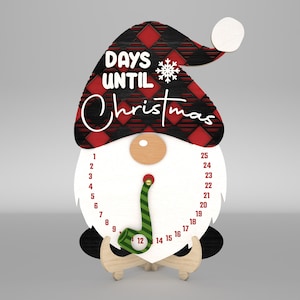 Puede incluir: Un gnomo de madera de cuenta atrás para Navidad con un gorro de cuadros rojos y negros. El gnomo tiene barba blanca y una pipa a rayas verdes y blancas. Los números del 1 al 25 están impresos en el cuerpo del gnomo. El texto "DAYS UNTIL Christmas" está impreso en el gorro.