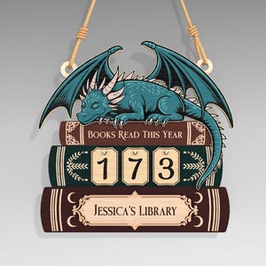 May include: Wooden sign with a teal dragon on a stack of books. The sign says "BOOKS READ THIS YEAR" and shows the number "173." The bottom book is labelled "Jessica's Library."