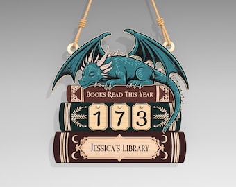 May include: Wooden sign featuring a teal dragon atop a stack of books. The sign reads "BOOKS READ THIS YEAR" and displays the number "173." The bottom book is labeled "Jessica's Library."