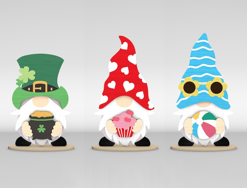 May include: Three wooden gnome figurines. One wears a green hat with a shamrock and holds a pot of gold. Another has a red hat with white hearts and holds a cupcake. The last gnome wears a blue hat with sunglasses and holds a beach ball.