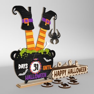 May include: Wooden Halloween countdown calendar with a witch's legs in a cauldron, a spider hanging from the cauldron, and a sign that says "Happy Halloween". The calendar has 31 days until Halloween.