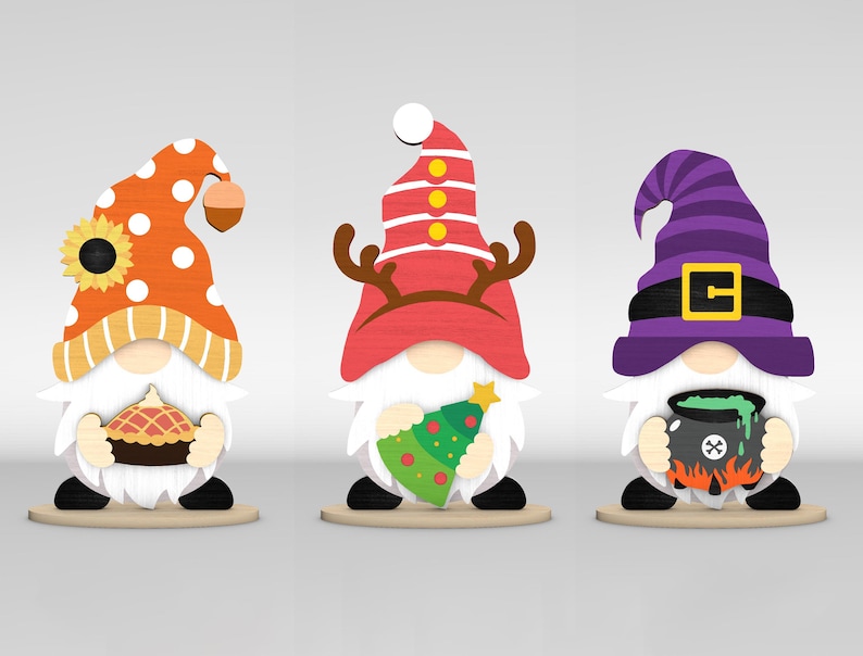 May include: Three wooden gnome figurines. The first gnome wears an orange hat with white polka dots and holds a pie. The second gnome has a red hat with antlers and holds a Christmas tree. The third gnome wears a purple witch hat and holds a cauldron.