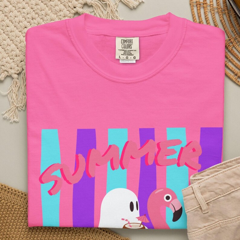 Spooky Summer T-shirt featuring playful ghosts in a fun Summerween-inspired design. Made with soft Comfort Colors fabric, this vintage-style shirt offers a comfortable relaxed fit for Halloween lovers, summer festivals, beach vacations, casual outings, and seasonal gift giving.