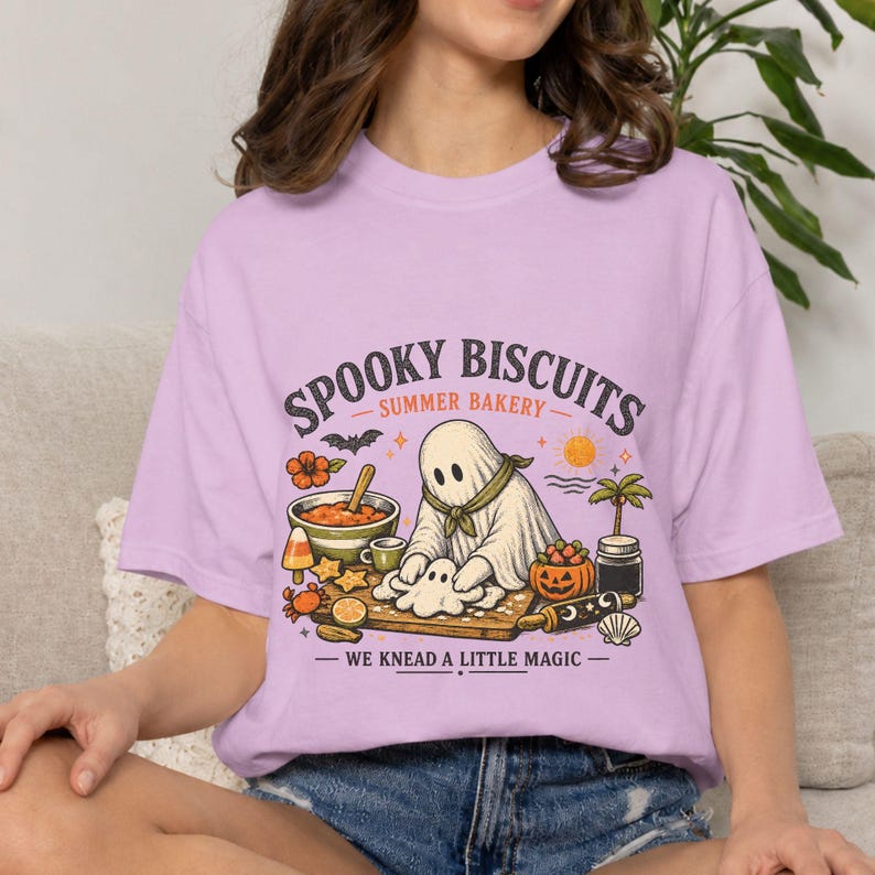 Summerween Halloween shirt with a whimsical ghost kneading dough in a magical spooky bakery. Featuring the fun saying “Spooky Biscuits,” this relaxed Comfort Colors tee is a charming choice for baking enthusiasts, Halloween lovers, casual summer outings, parties, and funny seasonal gifts.