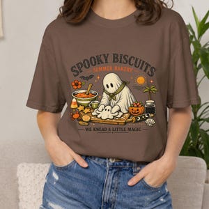 Comfort Colors Halloween tee featuring a charming ghost kneading biscuit dough beneath the phrase “Spooky Biscuits.” This playful Summerween shirt combines baking, Halloween magic, and warm summer energy, making it a cute seasonal top for bakers, vacations, parties, and everyday wear.