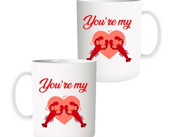 May include: Two white coffee mugs with a red heart and two red lobsters on each mug. The text "You're my" is written on each mug.