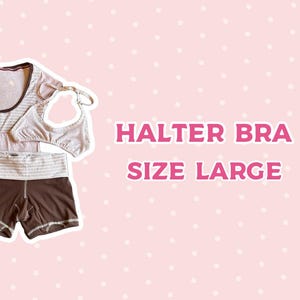 May include: A set of clothing including a light pink and white striped scoop neck top, a light pink halter bra, and dark brown shorts with a wide, light pink and white striped waistband. The text HALTER BRA SIZE LARGE is displayed.