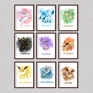 May include: Nine framed watercolor prints featuring various Pokémon characters. Each print showcases a different Pokémon with its name below. The color palettes vary, including pink, blue, green, black, purple, orange, yellow, and brown.