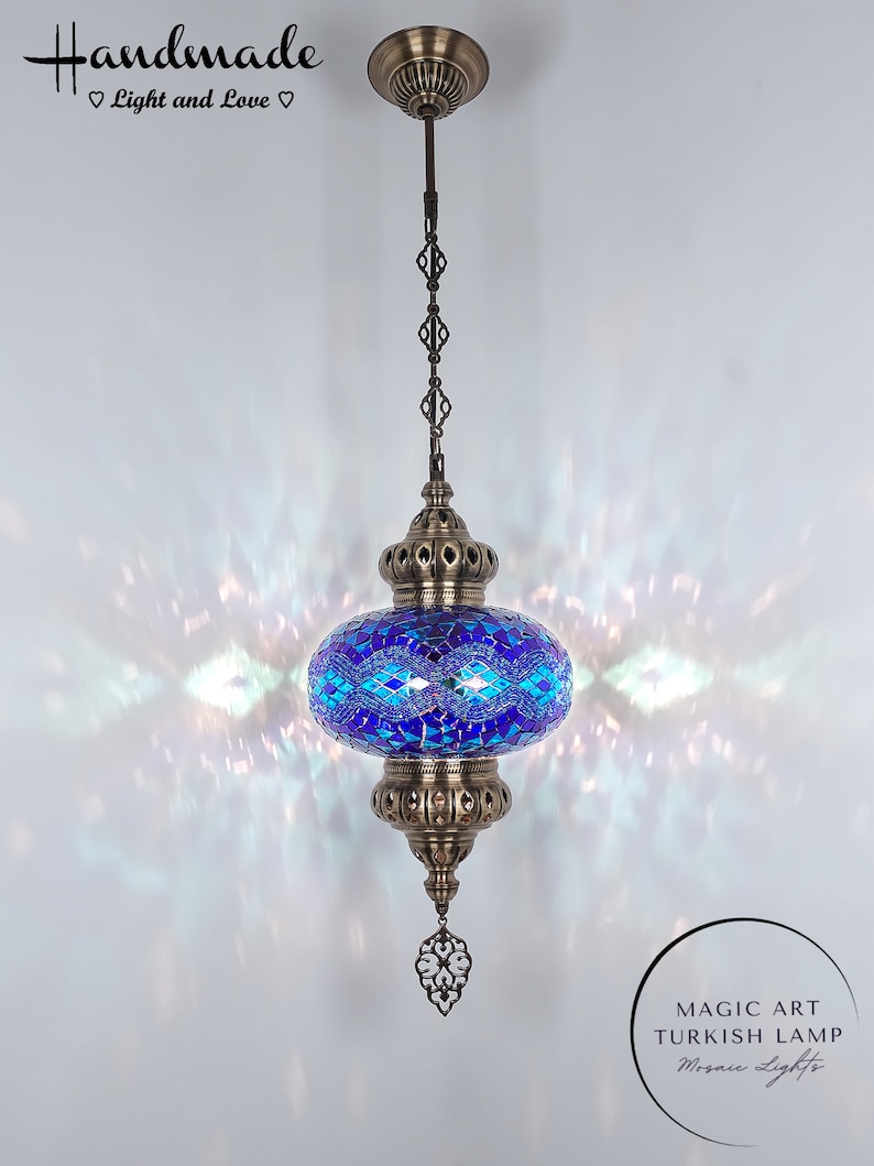 May include: A blue and green mosaic Turkish lamp with a brass chain and ceiling mount. The lamp is lit and casting a warm glow. The text "MAGIC ART TURKISH LAMP Mosaic Lights" is visible below the lamp.