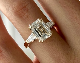 4 Carat Emerald Cut E VVS2 Lab Diamond Three Stone Ring: 14k Yellow Gold Double Prong Emerald Cut & Tapered Baguette Accents 3 Stone Ring