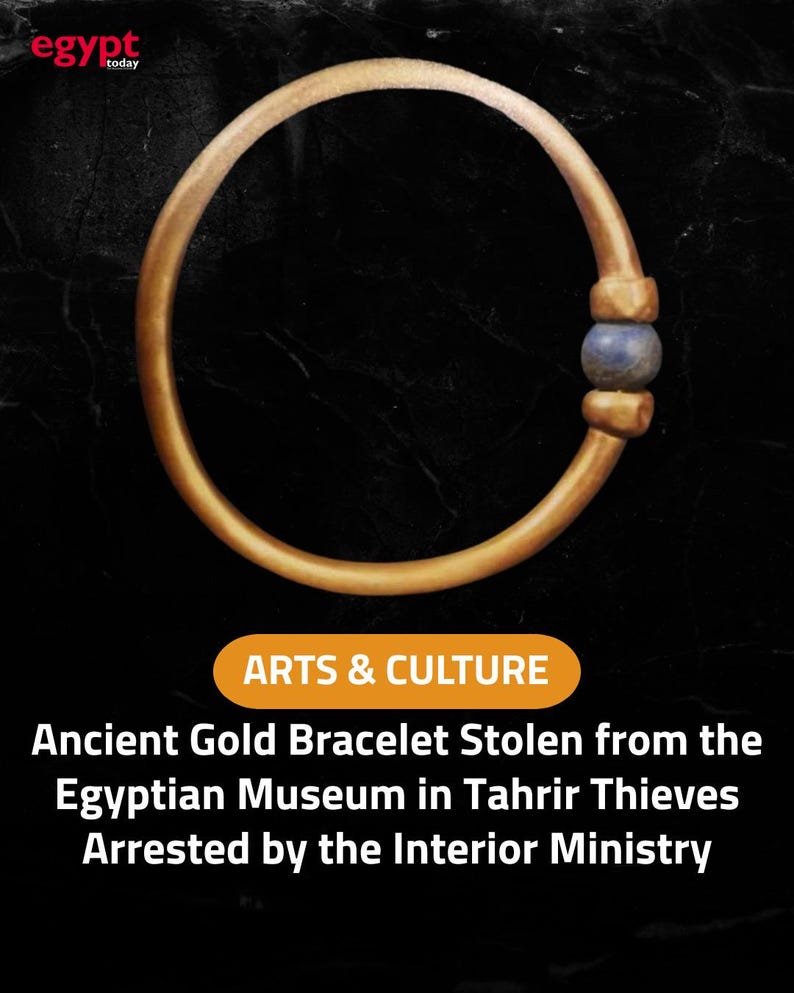 May include: A gold bracelet with a blue bead, set against a black background. The image includes text that reads "ARTS & CULTURE" and "Ancient Gold Bracelet Stolen from the Egyptian Museum in Tahrir Thieves Arrested by the Interior Ministry."