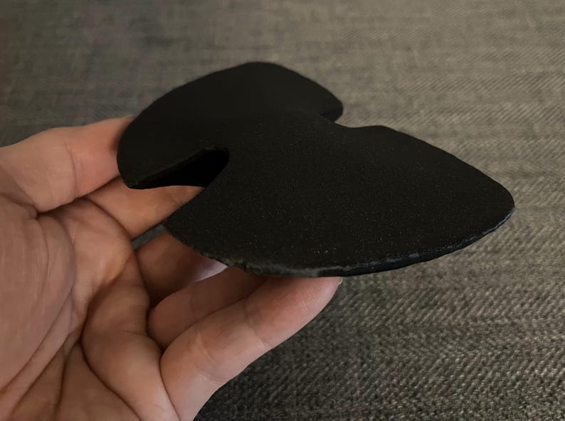 May include: Black foam knee pad with a cut-out shape for the kneecap.