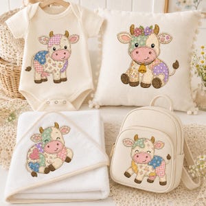 May include: A cream-colored baby bodysuit, a square throw pillow with pom-pom trim, a hooded towel, and a small backpack. Each item features a colorful patchwork-style cow illustration with floral and polka dot patterns in pastel tones.