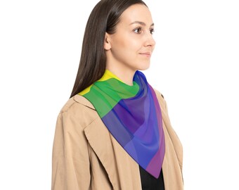 May include: A person wearing a tan coat with a rainbow patterned scarf around their neck.