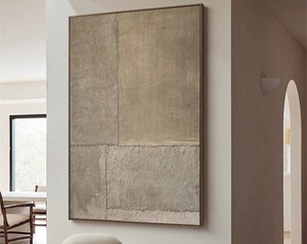 May include: A white, fluffy, round chair with wooden legs sits on a light brown rug in front of a large abstract painting with a brown and beige color scheme. A wooden stool sits next to the chair.