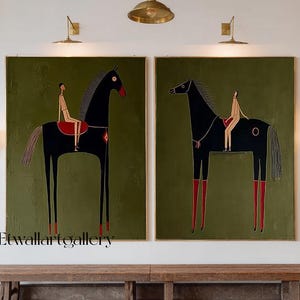 May include: Two framed wall art pieces featuring stylized black horses with riders on a green background. The horses have red accents on their legs and a red saddle. The artwork is displayed in a room with a wooden bench.