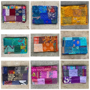May include: Nine colorful patchwork kantha quilts, each with a unique pattern and color combination. The quilts are made from recycled saris and are perfect for adding a touch of bohemian style to any home.