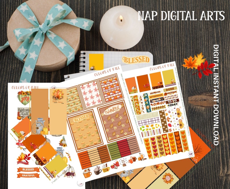 May include: A collection of fall-themed digital planner stickers and stationery. The designs include pumpkins, leaves, and the text "COLORS OF FALL", "BLESSED", and "THANKFUL". A gift box with a blue ribbon and a lit candle are also present.