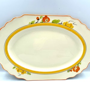 1920s Myott, Son & Co hand painted oval serving platter with orange and yellow flower design. Made in England.