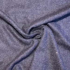 Puede incluir: Primer plano de una tela azul oscuro con un brillo sutil. La tela tiene una textura casi de punto.