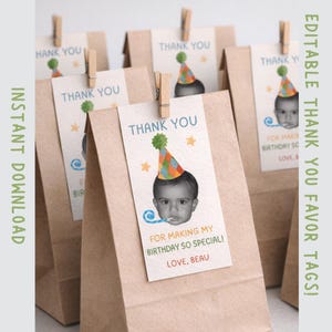 May include: Brown paper favor bags with attached tags that read "THANK YOU." Each tag features a baby wearing a party hat and the text "FOR MAKING MY BIRTHDAY SO SPECIAL! LOVE, BEAU." The bags are held closed with wooden clothespins.