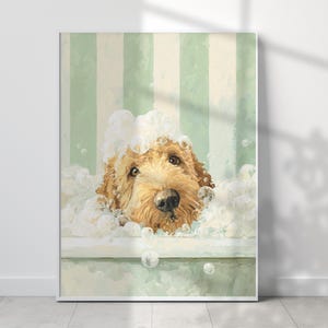 May include: A framed print depicting a golden doodle dog in a bath. The dog's head is surrounded by white bubbles, set against a light green and white striped backdrop. The dog's eyes and nose are visible.