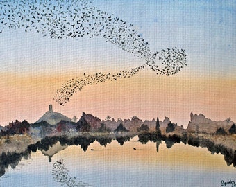 May include: A watercolor painting of a sunset over a lake with a silhouette of a town and a tower on a hill. A flock of birds flies in a swirling pattern across the sky.